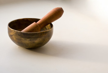 closeup of a tibetan singing bowl with its mallet 