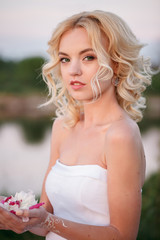 wedding at sunset with a beautiful bride and a large bouquet of peonies, peony wedding