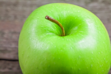 Ripe green apples on wooden background