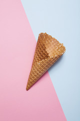 the Empty Ice Cream Cone on blue and pink background