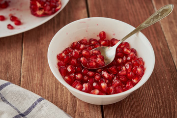 Delicious ripe pomegranates on a wooden table