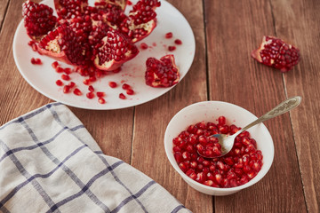 Delicious ripe pomegranates on a wooden table