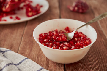 Delicious ripe pomegranates on a wooden table