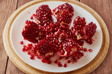 Delicious ripe pomegranates on a wooden table