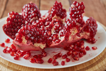 Delicious ripe pomegranates on a wooden table