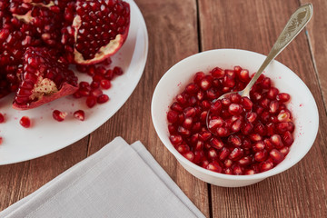 Delicious ripe pomegranates on a wooden table