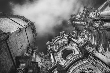Dramatic scene with clouds and facade of  Metropolitan Cathedral–Basilica of the Assumption of Our Lady of Valencia, Spain. Black and white image.  © elephotos
