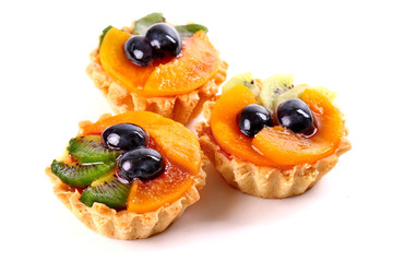 Sweet desserts with a kiwi, wine grapes and peaches