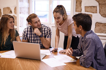 Young business team looking at presenter