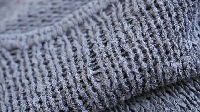High quality gray knitwork fine texture close-up slow tilt 4K 2160p 30fps UltraHD footage - Fine grey kitting made sweater texture details shallow DOF 3840X2160 UHD tilting video 