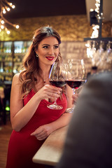 Couple toasting with glass of wine