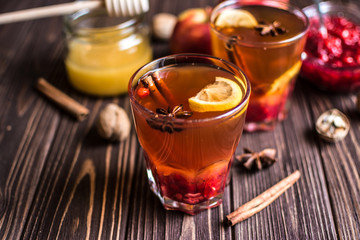 Tea with lemon and honey on wooden background