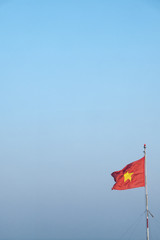 National flag of Vietnam waving with blue sky in the background