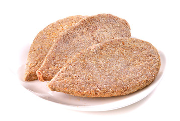 Frozen ground meat on a white plate