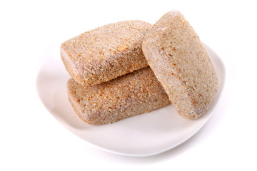 Frozen ground meat on a white plate