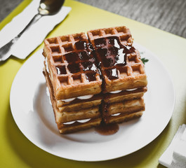 Waffle biscuits with jam close up on plate