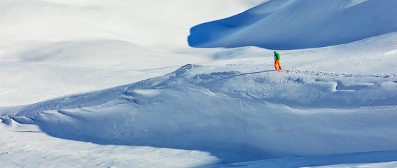 Freerider alpine skier walking in fresh snow