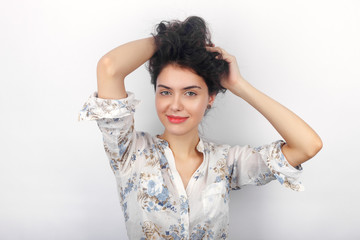 Naklejka premium Beauty portrait of young adorable fresh looking brunette woman playing with her long brown healthy curly braided hair. Emotion and facial expression concept.