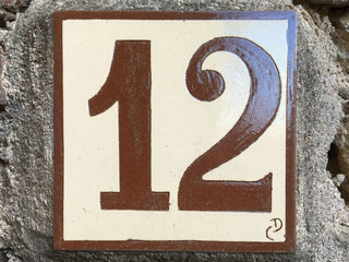 Ceramic tile with numer twelve 12