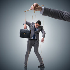 Businessman puppet being manipulated by boss