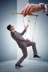 Businessman puppet being manipulated by boss