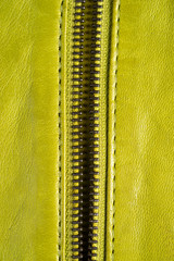 Green leather jacket zippers. Leather jacket macro details. Jacket zippers and pockets