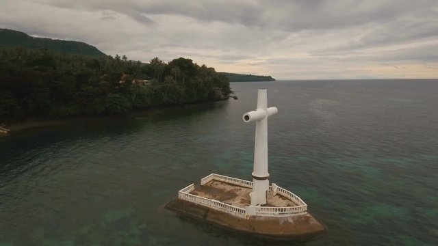 Aerial view Sunken Cemetery cross in Camiguin Island, Philippines. Large crucafix marking the underwater sunken cemetary of the coast of camiguin island near mindanao in the Philippines. Catholic