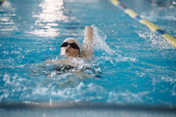 Young boy who does swimming and he lacks an arm, disabled person