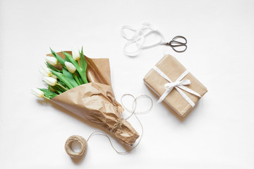 Top view bouquet of white tulips, box gift and accessories