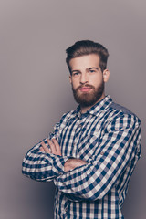 Fototapeta premium Portrait of serious confident young man with crossed hands