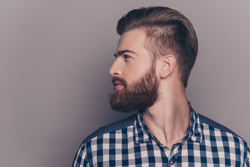 Handsome bearded young man isolated on gray background