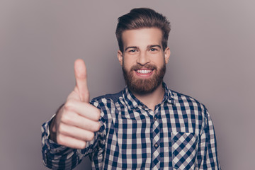 Handsome bearded smiling man showing thumb up