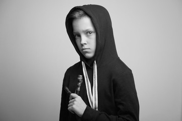 Fototapeta premium Teenage bad boy with slingshot and stylish haircut, studio shot