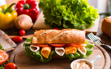 Delicious and Tasty sandwiches with turkey, ham, cheese, tomatoe