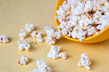 Inverted cup with yellow popcorn on the table