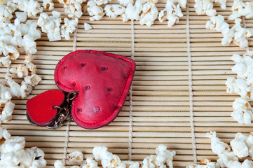Background frame of white popcorn and red heart