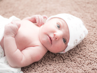 newborn baby on carpet