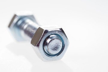 Large metal bolt with nut tightened isolated