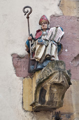 Gothic sculpture of a medieval saint man/Saint-Thiebaut statue on the outer wall of the Collegiate church in Thann, France Alsace.Gothic architecture