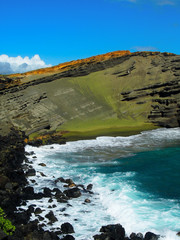 Green sand is formed naturally from volcanic rock on Hawaii's big island creating a green beach.