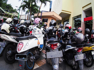 A group of motorbikes parked at a popular street in downtown Jogjakarta Indonesia,