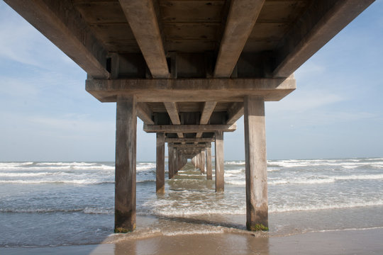 A pier juts into the ocean at the Gulf of Mexico in Texas.