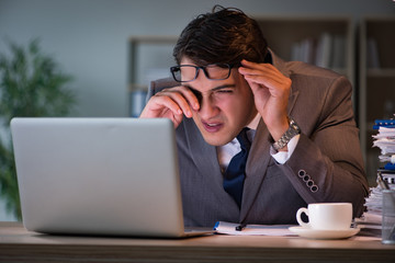 Businessman staying in the office for long hours