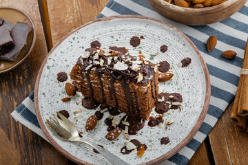 Chocolate Spartak cake for delicious dessert on a table. Traditional sweet food on a rustic plate. Top view.