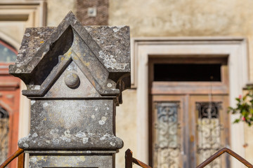 stone square decoration on pillar of fence