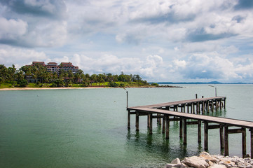 Beautiful Wooden Jetty  with Dramatic Sky and Green Island Backg