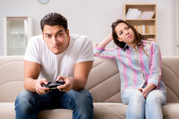 Obraz premium Young family suffering from computer games addiction