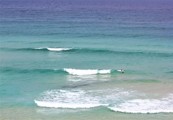 Sea and a surfing man