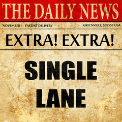 Single lane sign, newspaper article text
