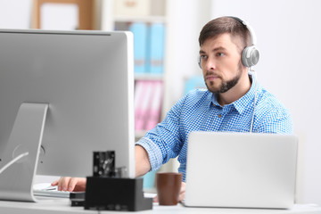 Handsome young programmer working in office